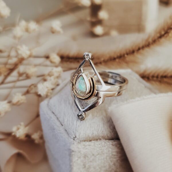 Mars Ring Set featuring a 7x5mm Welo Opal with tiny moissanite accents, sterling silver and 14k gold, with dried flowers nearby.