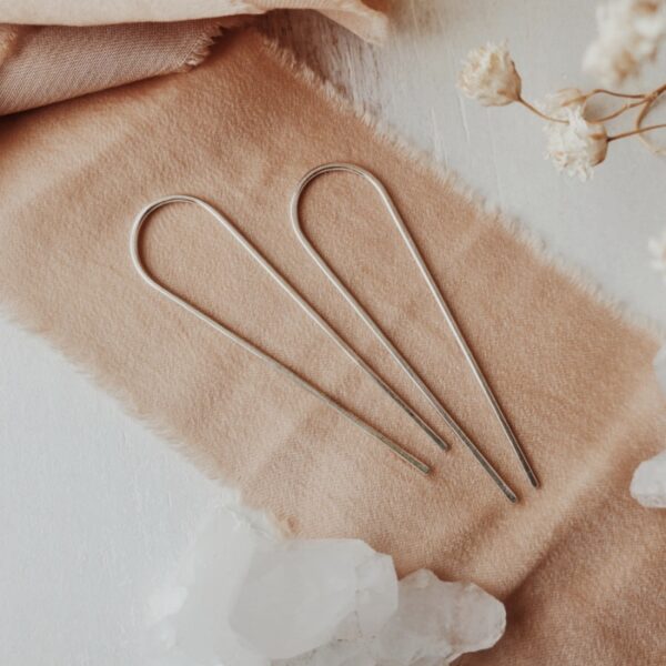 Droplet threader earrings in silver, displayed on silk ribbon with crystals and florals