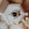 Luna y Terra Earth Ring Set in sterling silver with 8mm black obsidian center stone, 14k gold accents, and moissanite accent on secondary band, displayed in a velvet ring box.
