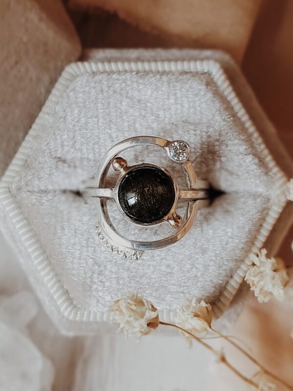 Luna y Terra Earth Ring Set in sterling silver with 8mm black obsidian center stone, 14k gold accents, and moissanite accent on secondary band, displayed in a velvet ring box.