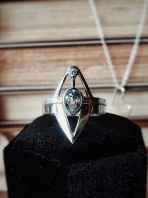Sterling silver Neptune ring set with pear aquamarine and moissanite accent, inspired by a trident design.