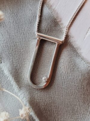 Salana – elongated silver modern arch necklace with moissanite.