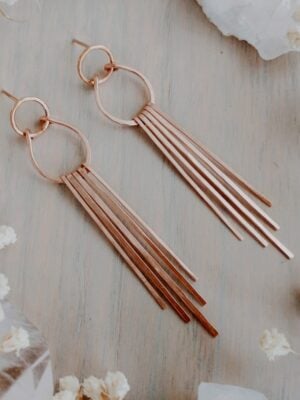 Stella Drop Fringe Earrings in 14k gold with circle post, horseshoe arc, and five cascading bars, displayed on velvet.