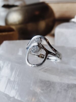 Sterling silver wave arch ring with two moissanite stones, featuring curved arches and layered movement