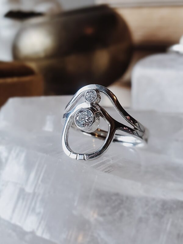 Sterling silver wave arch ring with two moissanite stones, featuring curved arches and layered movement