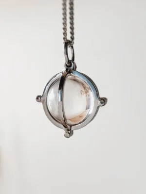 10mm natural rock crystal quartz sphere pendant hanging from a sterling silver chain